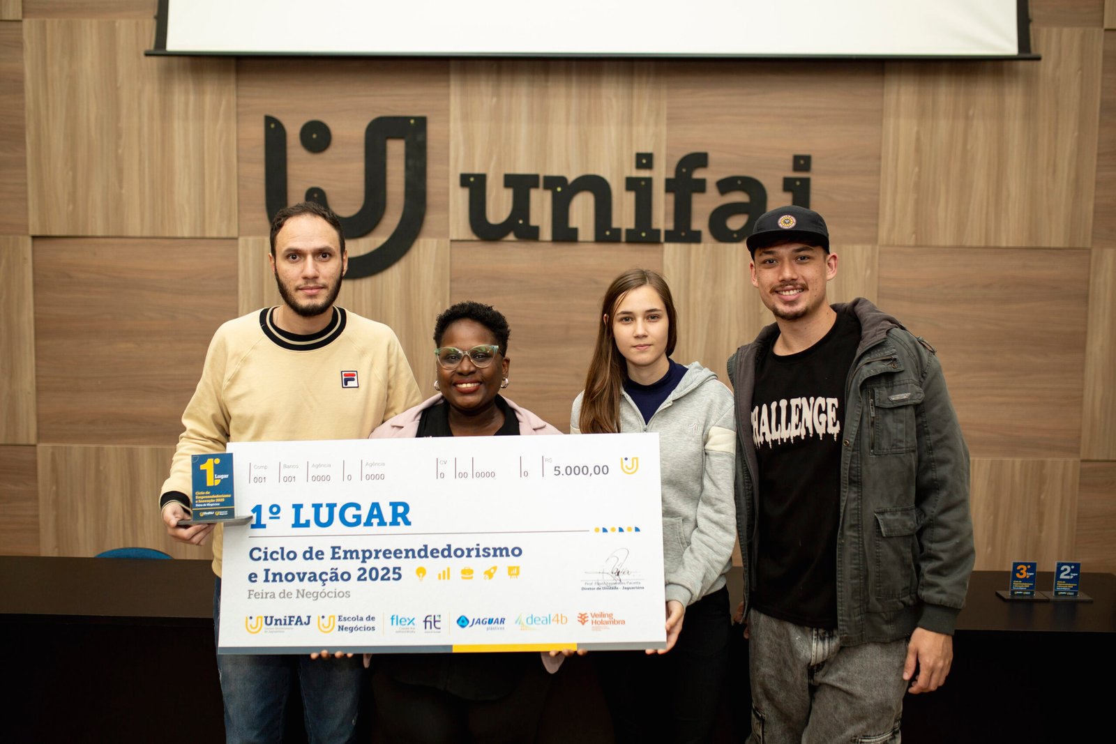 UniFAJ premia vencedores do Ciclo de Empreendedorismo e Inovação…..Projeto dos cursos de Engenharia Elétrica e Engenharia de Controle e Automação foi o grande vencedorNessa quarta-feira (11/06), o Centro Universitário de Jaguariúna (UniFAJ) realizou a cerimônia de premiação dos projetos vencedores do Ciclo de Empreendedorismo e Inovação. O evento reúne a apresentação dos trabalhos inovadores desenvolvidos pelos alunos ao longo do semestre e é organizado pela Escola de Negócios com apoio do Núcleo de Carreiras e Empregabilidade (Nuca) e do InovaEduK.Nessa edição, quarenta projetos foram apresentados e avaliados por profissionais e especialistas convidados. A avaliação dos projetos levou em consideração os seguintes critérios: originalidade e criatividade, viabilidade, qualidade da apresentação, inclusão e diversidade.Os estudantes Lucas Calisto, Erick Antônio, João Hatae, Sandra Lopes e Nayara Poggetti integraram o grupo vencedor. Para Sandra Lopes, aluna do 9º semestre de Engenharia de Controle e Automação, a premiação foi uma grande conquista e fechou de forma bem-sucedida a sua trajetória acadêmica e dos colegas.“Todo o conhecimento adquirido, os desafios enfrentados e os momentos de tensão vividos foram recompensados de maneira espetacular. É uma honra fazer parte dessa história e de estar ao lado de pessoas tão especiais que colaboraram para conquistarmos o 1º lugar”, salientas. “Como responsável pela programação, assumi uma grande responsabilidade em garantir o funcionamento e o sucesso do nosso projeto aos olhos dos avaliadores. Esta vitória confirma nossa determinação e garra, especialmente por ser uma das duas únicas mulheres no 9º semestre do nosso curso”, comemorou.Entre os avaliadores convidados para análise dos projetos apresentados no Ciclo de Empreendedorismo e Inovação estavam os gestores e docentes da UniFAJ, da Escola de Negócios e do InovaEduK, assim como especialistas e representantes de instituições convidadas, entre elas Arese Pharma, Eaton, Centro de Integração Empresa-Escola (CIEE), Conselho Regional de Engenharia e Agronomia (Crea) e Serviço Brasileiro de Apoio às Micro e Pequenas Empresas (Sebrae).O grupo vencedor recebeu a quantia de R$ 5 mil. Já o segundo e o terceiro colocados receberam as quantias de R$ 3 mil e R$ 2 mil, respectivamente. “Os estudantes realizam diagnósticos reais e apresentam soluções inovadoras para desafios empresariais, conectando o conhecimento da sala de aula com o mercado”, ressalta a gestora da Escola de Negócios da UniFAJ, professora Marili Siqueira. O Ciclo contou com patrocínios Jaguar Plásticos, Deal4B, Veiling e Flex/FIT.Confira a lista dos vencedores:1º lugar:Projeto: Strong – Prótese de Mão Robótica AutomatizadaCursos: Engenharia Elétrica e Engenharia de Controle e AutomaçãoResumo: O projeto trata-se de uma prótese de mão robótica acionada através de movimentos humanos captados por uma câmera.2º lugar:Projeto: Ração inovadora com subproduto da borra do farelo do óleo da sojaCurso: Engenharia AgronômicaResumo: Uma ração inovadora e sustentável com o subproduto a base da borra do farelo do óleo da soja.3º lugar:Projeto: Cobogó 2.0 UniFAJ: Uma Reinterpretação Sensorial e InclusivaCurso: Arquitetura e UrbanismoResumo: Este projeto apresenta uma versão moderna do tradicional cobogó – um elemento arquitetônico de vedação e ventilação – reinventado como uma estrutura modular e sensorial. Desenvolvido a partir de um módulo 2D repetido em rapport, o cobocó ganha forma tridimensional, mantendo proporções reais em um mockup 1:1 que demonstra sua aplicação prática.–Sobre UniFAJ e UniMAXCom 26 anos de atuação e mais de 10 mil alunos formados, o Centro Universitário de Jaguariúna (UniFAJ) e o Centro Universitário Max Planck (UniMAX), ambos do Grupo UniEduK, são instituições reconhecidas pelo MEC com nota máxima (5). São mais de 50 cursos nas áreas de Saúde, Humanas, Exatas, Tecnologia e Agronegócio, distribuídos entre 8 campi nas cidades de Jaguariúna e Indaiatuba, no interior de São Paulo. A estrutura inclui hospitais veterinários, centros de especialidades médicas, clínicas médicas e laboratórios modernos. O modelo de ensino é baseado em metodologias ativas de aprendizado e os cursos presenciais contam com pelo menos 50% de aulas práticas desde o início, além de certificações intermediárias nas modalidades EAD, extensão, pós-graduação e MBA.